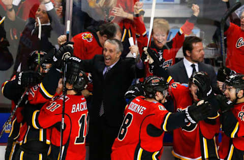 CALGARY, CANADA – APRIL 25: Bob Hartley (C) of the Calgary Flames celebrates their sixth goal with his players in their game against the Vancouver Canucks in Game Six of the Western Conference Quarterfinals during the 2015 Stanley Cup Playoffs at the Scotiabank Saddledome on April 25, 2015 in Calgary, Alberta, Canada. (Photo by Todd Korol/Getty Images)