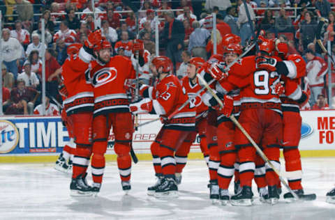 DETROIT, MI – JUNE 4: The Carolina Hurricanes celebrate after Ron Francis #10 scored the game winning goal in overtime against the Detroit Red Wings during game 1 of the 2002 Stanley Cup Finals on June 4, 2002 at Joe Louis Arena in Detroit, Michigan. The Hurricanes defeated the Red Wings 3-2. (Photo by Dave Sandford/Getty Images/NHLI)