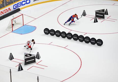 Jan 30, 2016; Nashville, TN, USA; Atlantic Division defenseman Erik Karlsson (bottom) of the Ottawa Senators skates against Pacific Division forward Taylor Hall (top) of the Edmonton Oilers during the Fastest Skater Challenge during the 2016 NHL All Star Game Skills Competition at Bridgestone Arena. Mandatory Credit: Aaron Doster-USA TODAY Sports