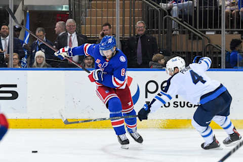 Apr 19, 2022; New York, New York, USA; New York Rangers defenseman Jacob Trouba (8) attempts a shot defended by Winnipeg Jets defenseman Neal Pionk (4) during the third period at Madison Square Garden. Mandatory Credit: Dennis Schneidler-USA TODAY Sports