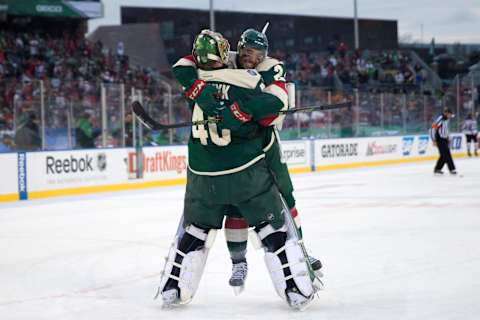 Minnesota Wild defenseman Matt Dumba (24) jumps into the arms of Minnesota Wild goalie 