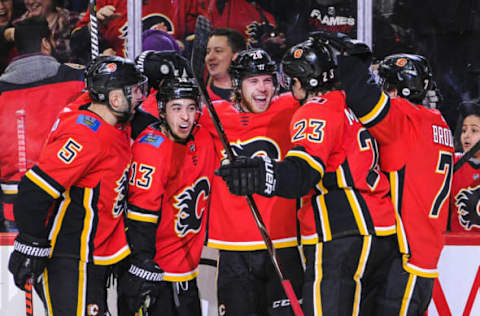 CALGARY, AB – DECEMBER 6: Elias Lindholm #28 (D) of the Calgary Flames celebrates with his teammates after scoring against the Minnesota Wild during an NHL game at Scotiabank Saddledome on December 6, 2018 in Calgary, Alberta, Canada. (Photo by Derek Leung/Getty Images)