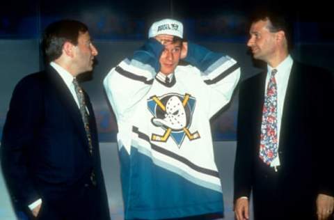 QUEBEC CITY, QC – JUNE 26: Paul Kariya tries on his hat and jersey after being drafted 4th overall in the 1993 NHL Entry Draft as he stands on stage with NHL Commissioner Gary Bettman on June 26, 1993, at the Quebec Coliseum in Quebec City, Quebec, Canada. (Photo by Bruce Bennett Studios/Getty Images)