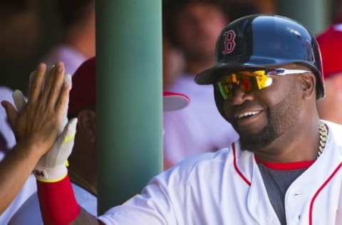 Jul 4, 2016; Boston, MA, USA; Boston Red Sox designated hitter David Ortiz (34) high fives a teammate after scoring a run against the Texas Rangers during the third inning at Fenway Park. Mandatory Credit: Winslow Townson-USA TODAY Sports