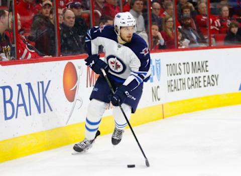 Feb 16, 2016; Raleigh, NC, USA; Winnipeg Jets defensemen Ben Chiarot (7) skates with the puck against the Carolina Hurricanes at PNC Arena. The Carolina Hurricanes defeated the Winnipeg Jets 2-1. Mandatory Credit: James Guillory-USA TODAY Sports