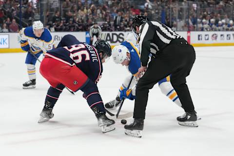 Apr 14, 2023; Columbus, Ohio, USA; Columbus Blue Jackets center Jack Roslovic (96) and Buffalo Sabres center Casey Mittelstadt (37) face off during the first period at Nationwide Arena. Mandatory Credit: Jason Mowry-USA TODAY Sports