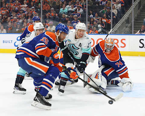 EDMONTON, CANADA – NOVEMBER 15: Darnell Nurse #25 and Stuart Skinner #74 of the Edmonton Oilers battle for the puck with Jaden Schwartz #17 of the Seattle Kraken in the first period at Rogers Place on November 15, 2023 in Edmonton, Alberta, Canada. (Photo by Lawrence Scott/Getty Images)