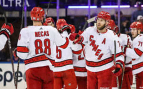 Mar 21, 2023; New York, New York, USA; Carolina Hurricanes center Martin Necas (88) and defenseman Jaccob Slavin (74) celebrate after defeating the New York Rangers 3-2 at Madison Square Garden. Mandatory Credit: Wendell Cruz-USA TODAY Sports