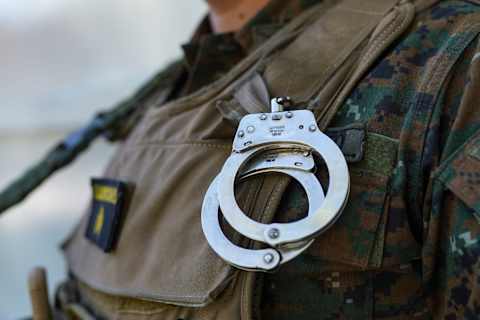 Detail of handcuffs placed on the uniform of Police in the Tutunichapa Community, in El Salvador’s Nayib Bukele. (Photo by Camilo Freedman/SOPA Images/LightRocket via Getty Images)