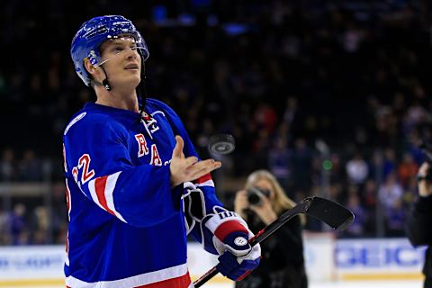 Dec 27, 2016; New York, NY, USA; New York Rangers defenseman Nick Holden (22) throws a puck to a fan after defeating the Ottawa Senators at Madison Square Garden. Mandatory Credit: Adam Hunger-USA TODAY Sports