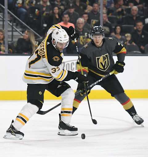 LAS VEGAS, NEVADA – OCTOBER 08: Patrice Bergeron #37 of the Boston Bruins controls the puck against Valentin Zykov #7 of the Vegas Golden Knights in the first period of their game at T-Mobile Arena on October 8, 2019 in Las Vegas, Nevada. The Bruins defeated the Golden Knights 4-3. (Photo by Ethan Miller/Getty Images)