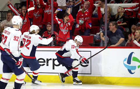 RALEIGH, NC – MARCH 28: Jakub Vrana #13 of the Washington Capitals scores a game tying goal and celebrates with teammate Carl Hagelin #62 during an NHL game on March 28, 2019 at PNC Arena in Raleigh, North Carolina. (Photo by Gregg Forwerck/NHLI via Getty Images)