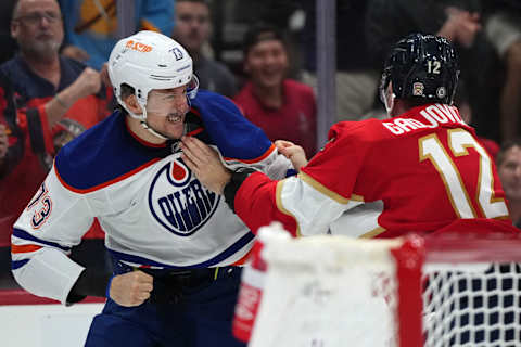 Nov 20, 2023; Sunrise, Florida, USA; Edmonton Oilers defenseman Vincent Desharnais (73) and Florida Panthers left wing Jonah Gadjovich (12) fight during the second period at Amerant Bank Arena. Mandatory Credit: Jasen Vinlove-USA TODAY Sports