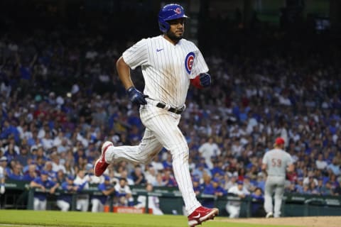 Aug 1, 2023; Chicago, Illinois, USA; Chicago Cubs first baseman Jeimer Candelario (9) beats out an infield single against the Cincinnati Reds during the third inning at Wrigley Field. Mandatory Credit: David Banks-USA TODAY Sports