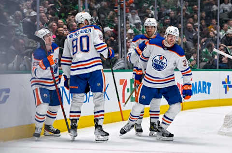 Dec 21, 2022; Dallas, Texas, USA; Edmonton Oilers right wing Kailer Yamamoto (56) and left wing Warren Foegele (37) and defenseman Markus Niemelainen (80) and defenseman Evan Bouchard (2) celebrate after Foegele scores a goal against the Dallas Stars during the third period at the American Airlines Center. Mandatory Credit: Jerome Miron-USA TODAY Sports