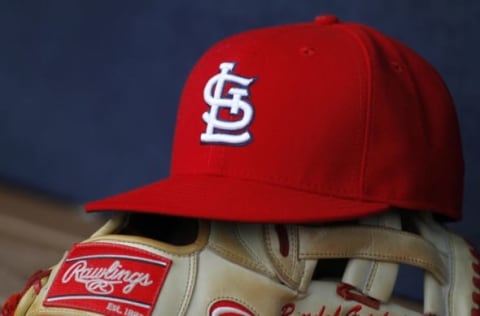 Oct 4, 2015; Atlanta, GA, USA; Detailed view of St. Louis Cardinals hat and glove in the dugout against the Atlanta Braves in the ninth inning at Turner Field. The Braves defeated the Cardinals 2-0. Mandatory Credit: Brett Davis-USA TODAY Sports