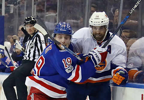 Jesper Fast #19 of the New York Rangers hitakes a slapshot Andrew Ladd #16 of the New York Islanders (Photo by Bruce Bennett/Getty Images)