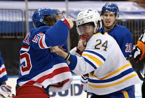 MARCH 02: Ryan Lindgren #55 of the New York Rangers and Dylan Cozens #24 of the Buffalo Sabres fight (Photo by Bruce Bennett/Getty Images)