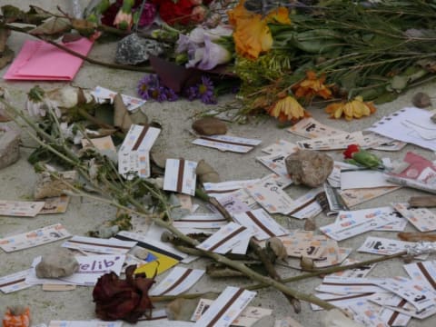 The grave of Simone de Beauvoir and Jean-Paul Sartre, decorated with flowers and metro tickets