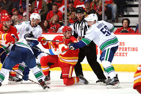 CALGARY, ALBERTA – OCTOBER 05: Sean Monahan #23 of the Calgary Flames skates against Bo Horvat #53 of the Vancouver Canucks at Scotiabank Saddledome on October 05, 2019 in Calgary, Canada. (Photo by Gerry Thomas/NHLI via Getty Images)