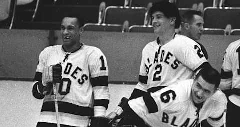 L.A. Blades wing Willie O’Ree talking with teammates before a game.