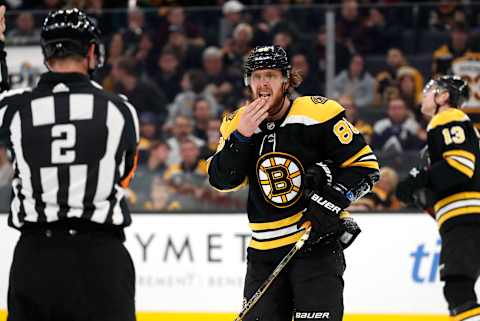 BOSTON, MA – DECEMBER 07: Boston Bruins right wing David Pastrnak (88) asks if he is bleeding to referee Jon McIssac (2) during a game between the Boston bruins and the Colorado Avalanche on December 7, 2019, at TD Garden in Boston, Massachusetts. (Photo by Fred Kfoury III/Icon Sportswire via Getty Images)