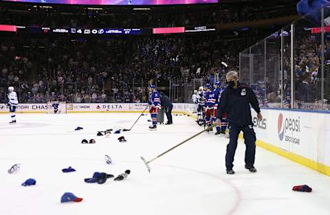 NEW YORK, NEW YORK – JANUARY 02: Hats are gathered following a second period hattrick by Mika Zibanejad #93 of the New York Rangers against the Tampa Bay Lightning at Madison Square Garden on January 02, 2022 in New York City. (Photo by Bruce Bennett/Getty Images)