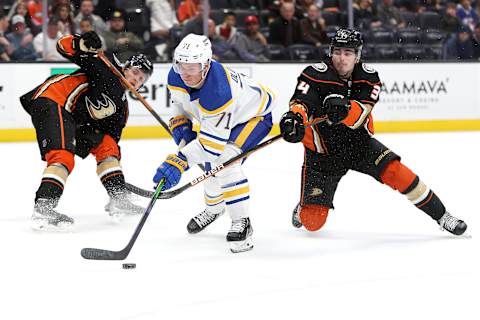 ANAHEIM, CALIFORNIA – OCTOBER 28: Victor Olofsson #71 of the Buffalo Sabres controls the puck through the defense of Jamie Drysdale #34 and Troy Terry #16 of the Anaheim Ducks during overtime of a game at Honda Center on October 28, 2021 in Anaheim, California. (Photo by Sean M. Haffey/Getty Images)