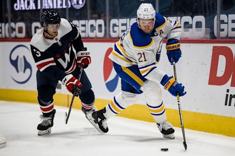 WASHINGTON, DC – APRIL 15: Kyle Okposo #21 of the Buffalo Sabres handles the puck against the Washington Capitals during the first period at Capital One Arena on April 15, 2021 in Washington, DC. (Photo by Scott Taetsch/Getty Images)