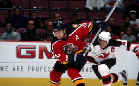 2002 Season: Pavel Bure fires as Scott Stevens chases. (Photo by Lisa Meyer/Getty Images)