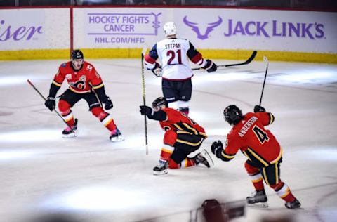 CALGARY, AB – NOVEMBER 05: Matthew Tkachuk #19 of the Calgary Flames celebrates after scoring the overtime winning goal against the Arizona Coyotes with Mikael Backlund #11 and Rasmus Andersson #4 of the Calgary Flames on November 5, 2019 at the Scotiabank Saddledome in Calgary, Alberta, Canada. (Photo by Brett Holmes/NHLI via Getty Images)