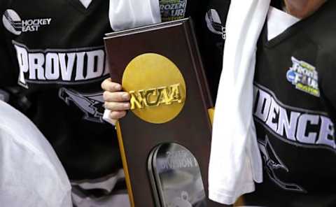 Apr 11, 2015; Boston, MA, USA; Providence College Friar players hold the trophy after defeating the Boston University Terriers 4-3 in the championship game of the Frozen Four college ice hockey tournament at TD Garden. Mandatory Credit: Winslow Townson-USA TODAY Sports