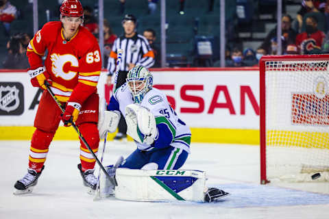 Jan 29, 2022; Calgary, Alberta, CAN; Vancouver Canucks goaltender Thatcher Demko (35) guards his net as Calgary Flames center Adam Ruzicka (63) tries to score during the third period at Scotiabank Saddledome. Mandatory Credit: Sergei Belski-USA TODAY Sports