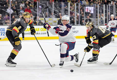 LAS VEGAS, NEVADA – MARCH 19: Zach Whitecloud #2 of the Vegas Golden Knights, Patrik Laine #29 of the Columbus Blue Jackets and Paul Cotter #43 of the Golden Knights vie for the puck in the third period of their game at T-Mobile Arena on March 19, 2023 in Las Vegas, Nevada. The Golden Knights defeated the Blue Jackets 7-2. (Photo by Ethan Miller/Getty Images)