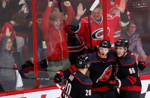 Carolina’s Warren Foegele (13), Sebastian Aho (20) and Teuvo Teravainen (86) celebrate after Foegele scored during the second period of the Carolina Hurricanes’ game against the Washington Capitals at PNC Arena in Raleigh, N.C. The Hurricanes won, 5-0. (Ethan Hyman/Raleigh News & Observer/TNS via Getty Images)