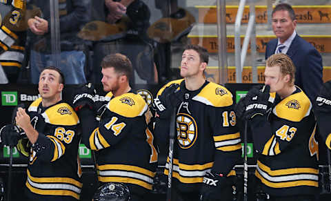 BOSTON – SEPTEMBER 23: From left, Boston Bruins players Brad Marchand (63), Chris Wagner (14), Charlie Coyle (13), Danton Heinen (43) and head coach Bruce Cassidy stand on the Boston bench during the singing of the national anthem. The Boston Bruins host the Philadelphia Flyers in a pre-season NHL hockey game at TD Garden in Boston on Sep. 23, 2019. (Photo by Jim Davis/The Boston Globe via Getty Images)