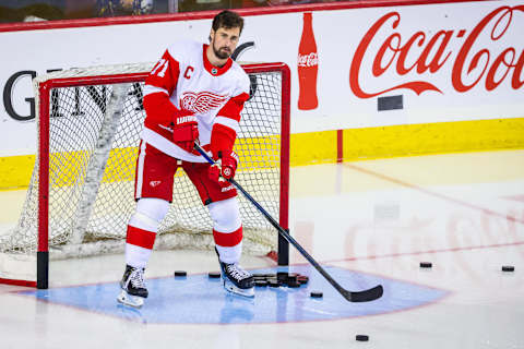 Detroit Red Wings center Dylan Larkin (71) passes the pucks during the warmup period against the Calgary Flames at Scotiabank Saddledome. (Sergei Belski-USA TODAY Sports)