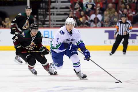 Mar 5, 2015; Glendale, AZ, USA; Vancouver Canucks defenseman Luca Sbisa (5) skates the puck against the Arizona Coyotes at Gila River Arena. The Coyotes won 3-2 in a shootout. Mandatory Credit: Joe Camporeale-USA TODAY Sports