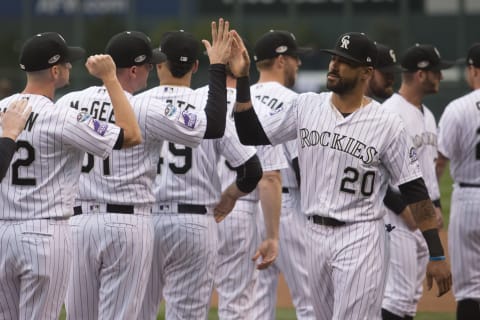 Denver, CO – OCTOBER 07: Colorado Rockies first baseman Ian Desmond (20) high fives teammates during the Milwaukee Brewers vs Colorado Rockies National League Division series game 3 at Coors Field on October 7, 2018 in Denver, CO. (Photo by Kyle Emery/Icon Sportswire via Getty Images)