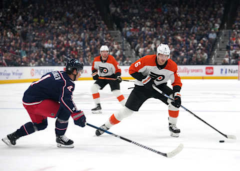 COLUMBUS, OHIO – OCTOBER 12: Travis Sanheim #6 of the Philadelphia Flyers skates with the puck against Cole Sillinger #4 of the Columbus Blue Jackets during the first period at Nationwide Arena on October 12, 2023 in Columbus, Ohio. (Photo by Jason Mowry/Getty Images)