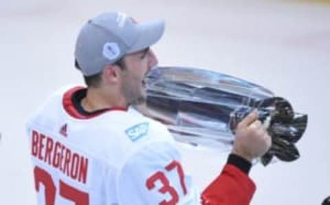 Sep 29, 2016; Toronto, Ontario, Canada; Team Canada center Patrice Bergeron (37) hoists the World Cup of Hockey championship trophy after game two of the World Cup of Hockey final against Team Europe at Air Canada Centre. Mandatory Credit: Dan Hamilton-USA TODAY Sports