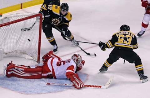 BOSTON – MARCH 6: Boston Bruins’ Brad Marchand (63) beats Detroit goalie Jimmy Howard in overtime to give Boston a 6-5 victory and himself a hat trick. The Boston Bruins host the Detroit Red Wings in a regular season NHL hockey game at TD Garden in Boston on March 6, 2018. (Photo by Jim Davis/The Boston Globe via Getty Images)