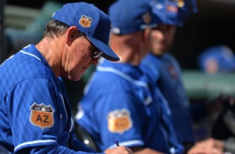 Mar 18, 2017; Surprise, AZ, USA; Kansas City Royals manager Ned Yost (3) writes on a lineup during the sixth inning against the Cleveland Indians at Surprise Stadium. Mandatory Credit: Jake Roth-USA TODAY Sports