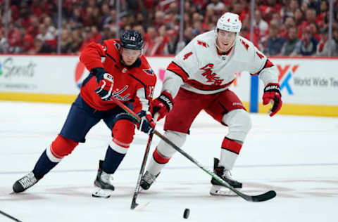 WASHINGTON, DC – OCTOBER 05: Jakub Vrana #13 of the Washington Capitals and Haydn Fleury #4 of the Carolina Hurricanes battle for the puck in the first period at Capital One Arena on October 5, 2019 in Washington, DC. (Photo by Patrick McDermott/NHLI via Getty Images)