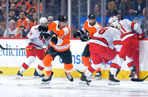 PHILADELPHIA, PA – MARCH 05: Michael Raffl #12 of the Philadelphia Flyers gets the puck away from Brady Skjei #76 of the Carolina Hurricanes in the first period at Wells Fargo Center on March 5, 2020 in Philadelphia, Pennsylvania. (Photo by Drew Hallowell/Getty Images)