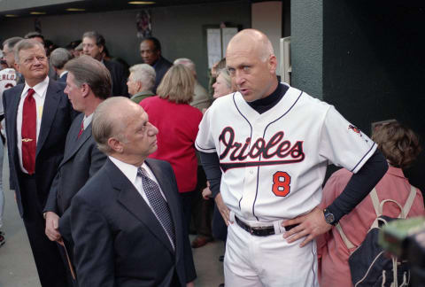 BALTIMORE, MD – OCTOBER 6: Owner Peter Anggelos talks with Cal Rippken Jr. #8 of the Baltimore Orioles who is be honored by the Orioles organization prior to the final game of his Major League baseball career against the Boston Red Sox October 6, 2001 at Oriole Park at Camden Yards in Baltimore, Maryland. Cal Ripken Jr.played for the Orioles from 1981-2001. (Photo by Focus on Sport/Getty Images)