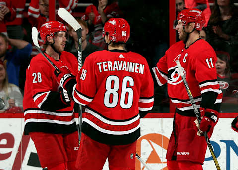 RALEIGH, NC – DECEMBER 23: Elias Lindholm #28 and Teuvo Teravainen #86 of the Carolina Hurricanes celebrate a powerplay goal scored by Jordan Staal #11 against the Buffalo Sabres during an NHL game on December 23, 2017 at PNC Arena in Raleigh, North Carolina. (Photo by Gregg Forwerck/NHLI via Getty Images)