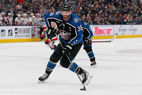 Jan 31, 2023; Columbus, Ohio, USA; Columbus Blue Jackets center Boone Jenner (38) wrists a shot on goal against the Washington Capitals during the second period at Nationwide Arena. Mandatory Credit: Russell LaBounty-USA TODAY Sports