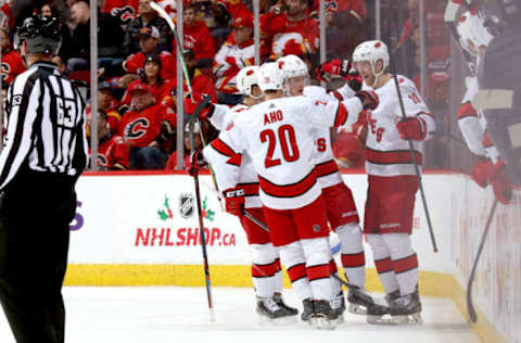 CALGARY, ALBERTA – DECEMBER 14: Dougie Hamilton #19, Sebastian Aho #20 and teammates of the Carolina Hurricanes celebrate a goal against the Calgary Flames at Scotiabank Saddledome on December 14, 2019 in Calgary, Canada. (Photo by Gerry Thomas/NHLI via Getty Images)