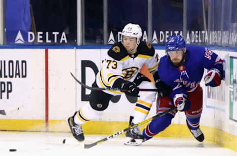 Feb 10, 2021; New York, New York, USA; Charlie McAvoy #73 of the Boston Bruins checks Ryan Lindgren #55 of the New York Rangers against the boards during the second period at Madison Square Garden. Mandatory Credit: Bruce Bennett/Pool Photo-USA TODAY Sports